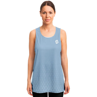 A woman wears a light blue Synergetic Heroes tank top with a minimalist design and subtle logo. Perfect for workouts or casual wear, offering comfort and style.