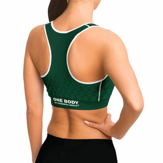 Woman wearing a green Synergetic Heroes racerback sports bra with white trim and 'One Body of Powerful Souls' text on the back, posing against a white background. This stylish, supportive sports bra is perfect for workouts, yoga, and active lifestyles.