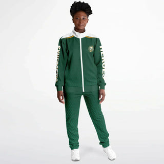 Woman in a green Synergetic Heroes tracksuit with bold sleeve branding, standing against a white background. This stylish, comfortable athleisure set is perfect for casual wear, workouts, and active lifestyles. Shop Synergetic Heroes apparel today!